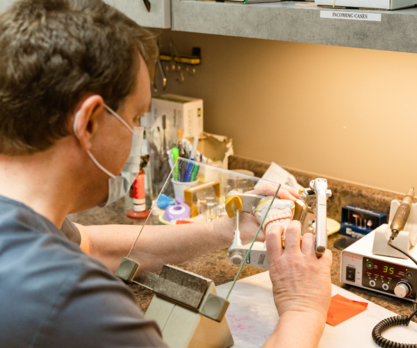 Dr. Rodney Baier examining a dental model at his Sandy Springs practice